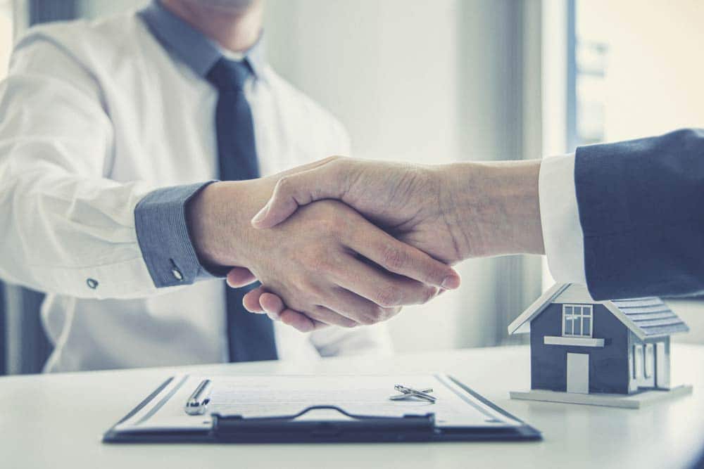 Consultant and customers shake hands
